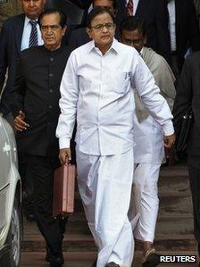 India"s Finance Minister Palaniappan Chidambaram walks as he leaves his office to present the 2013/14 federal budget in New Delhi February 28, 2013.