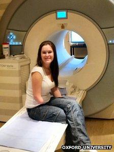 Kirsty Mason sits by an MRI machine in hospital