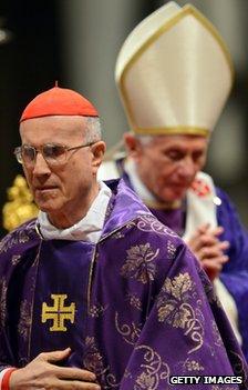 Cardinal Tarcisio Bertone with Pope Benedict XVI in the background, at St Peter's Basilica, 13 February