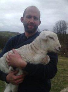 Alan Jackson holding Joan the lamb