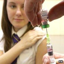 A school girl prepares to have her measles jab