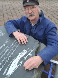 Malcolm Gray with the memorial stone