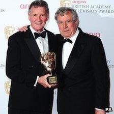 Michael Palin with his Bafta Fellowship award, Terry Jones