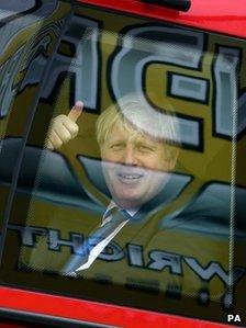 London mayor Boris Johnson sits in a new London bus during a tour of Wrightbus factories in Ballymena and Antrim