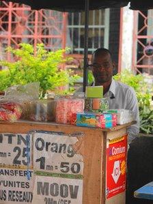 Konan Kouassi Vercruysses behind his phone booth in Abidjan