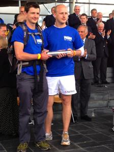 Two walkers hold the silver baton