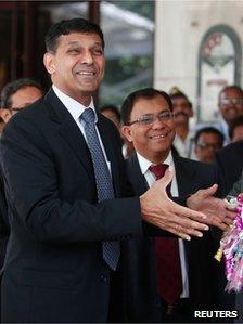 Raghuram Rajan, newly appointed governor of Reserve Bank of India (RBI), gestures while posing for the photographers after his arrival at the bank"s headquarters in Mumbai September 4, 2013