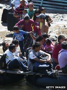 Undocumented Guatemalans prepare to cross the Suchiate River from Guatemala into Talisman, Mexico 1 August 2013