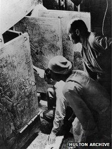 Carter and his assistant opening the tomb