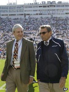 Penn State president Graham Spanier, left, and head football coach Joe Paterno talk before an NCAA college football game against Iowa in State College, Pennsylvania 8 October 2011