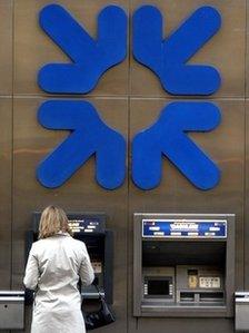 A woman using an RBS cash machine