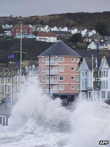 Winds lash the waves up onto the promenade during high tide in Aberystwyth