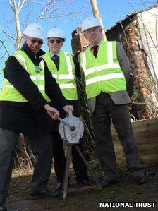 Bob Shaw (left) signalling the start of the restoration work by sounding an air raid siren with Ian Barber, from Severn Waste, and Dennis Williams of the heritage group outside the building