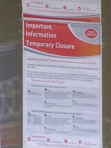 Temporary closure notice on a post office window