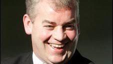 Stephen Vaughan, who has short grey hair, smiles at the camera