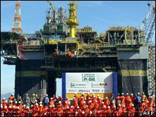 Petrobras workers in front of an oil platform