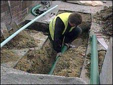 Man digging up road to lay cable