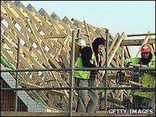 Workers building a house