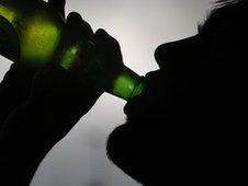 Boy drinking a bottle of beer