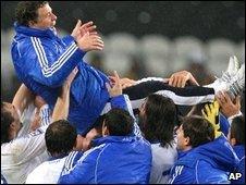 The Greeks celebrate by hoisting coach Otto Rehhagel aloft