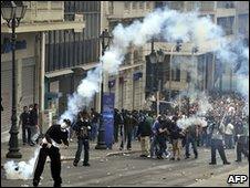 Protestors face police near the Parliament building in the center of Athens