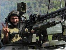 Pakistani soldier in tank making victory salute