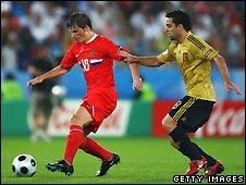 Andrei Arshavin of Russia (left. red) and Xavi Hernandez of Spain