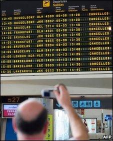 A passenger takes a photograph of a departure board displaying cancelled flights at Bilbao's airport in Loiu, northern Spain, on May 8, 2010.