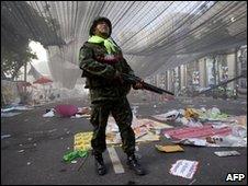 Soldier stands in the main protest area in Bangkok on 19 May 2010