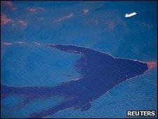 A ship makes its way through surface oil in the Gulf of Mexico