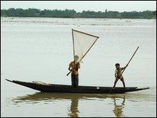 two lads in boat with fishing net