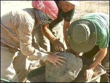 Lee Jones, Daniel Jones and Tim Lewis remove raw clay cooking pot for environmental sampling and conservation