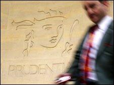 Man walking past a Prudential sign