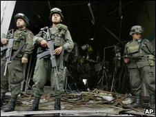 Colombian police stand outside a bank in Corinto which officials said was attacked by Farc rebels on 26 April