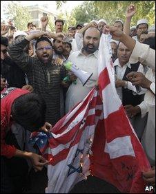 Pakistani Muslims burn flags during an anti-Facebook demonstration