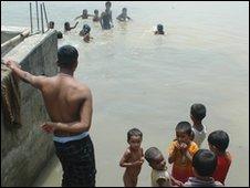 Children play in flooded fields