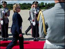 U.S. Secretary of State Hillary Rodham Clinton walks through an honor cordon prior to departing K-16 Air Base in Seoul