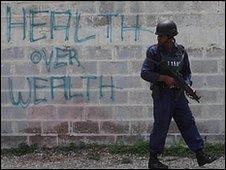 A police officer stands guard near Tivoli Gardens, Kingston