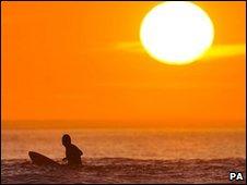 A surfer at a beach in Devon