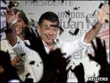 Juan Manuel Santos celebrates his victory in the first round of Colombia's presidential election