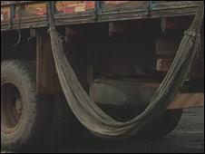 A dirty hammock slung from a truck