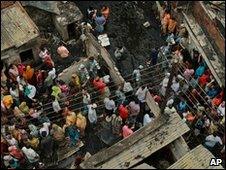 People gather in the street where the blaze took place