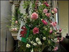 Flowers and Welsh flag at St Mary The Virgin Church in Dover