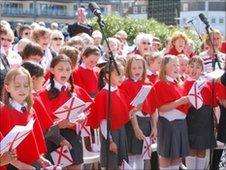 Schoolchildren singing An Island Home on Liberation Day