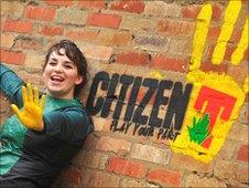 Anna Meldrum in her tent dress with the yellow hand logo