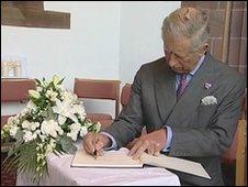 Prince Charles signs a book of condolence