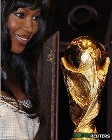 Model Naomi Campbell poses with the World Cup trophy in Paris, 1 June