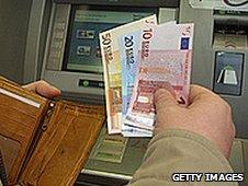 Man withdrawing euros from cashpoint (file pic)