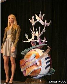 Artist Lauren Voiers and a model of her John Lennon Peace Monument