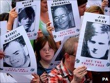 Campaigners hold posters of the Bloody Sunday victims